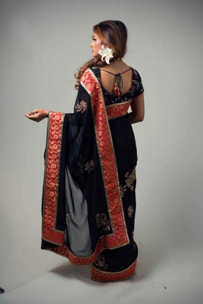 black, gold, and red sari